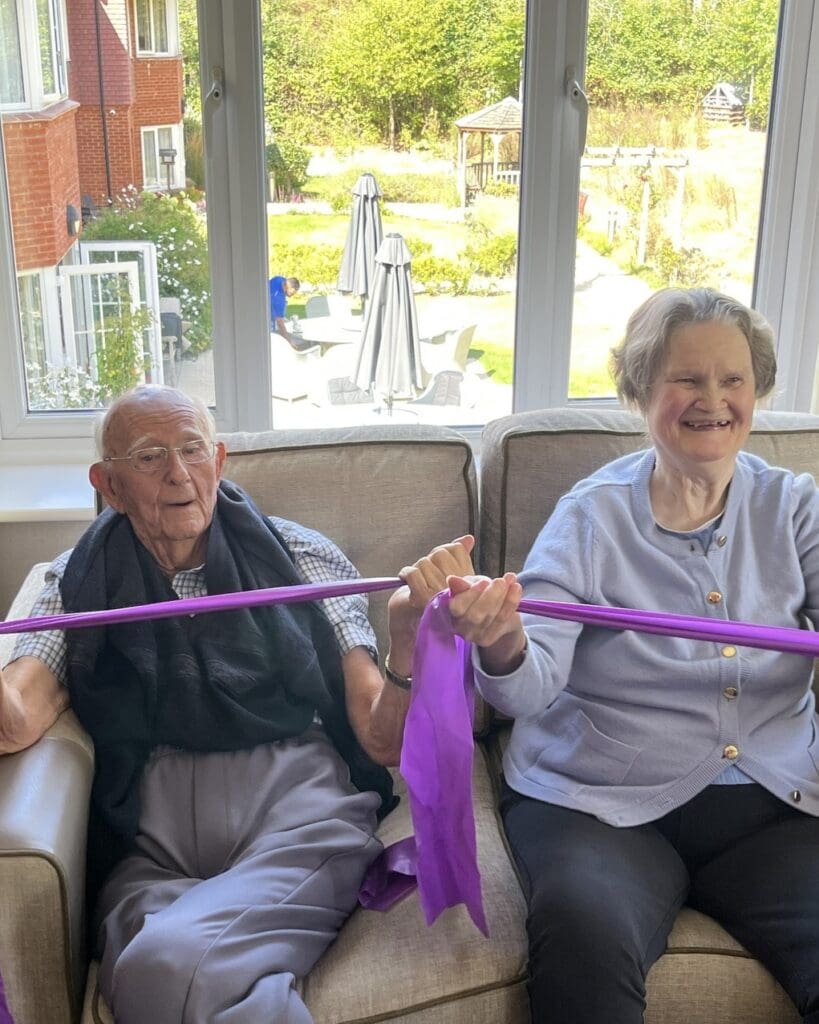 Two of our Hartfield House care home residents enjoying a seated exercise class.